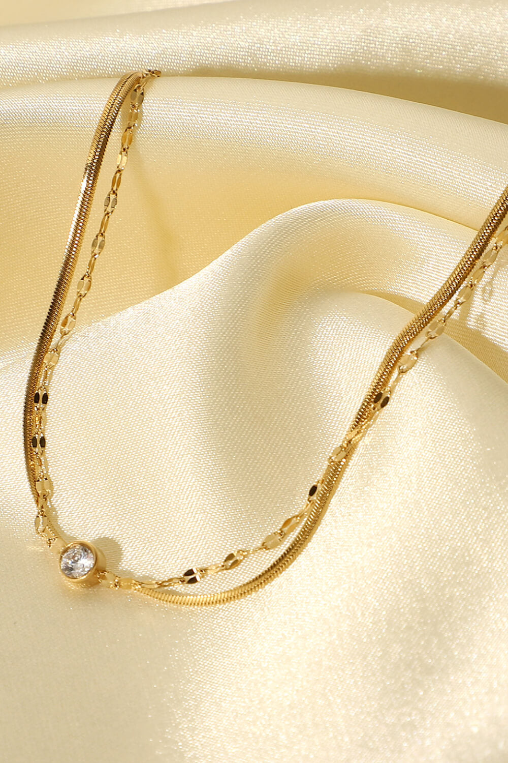 Close view of the fine gold-tone chains and rhinestone detail