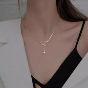 Model wearing silver star necklace with small dangling star detail