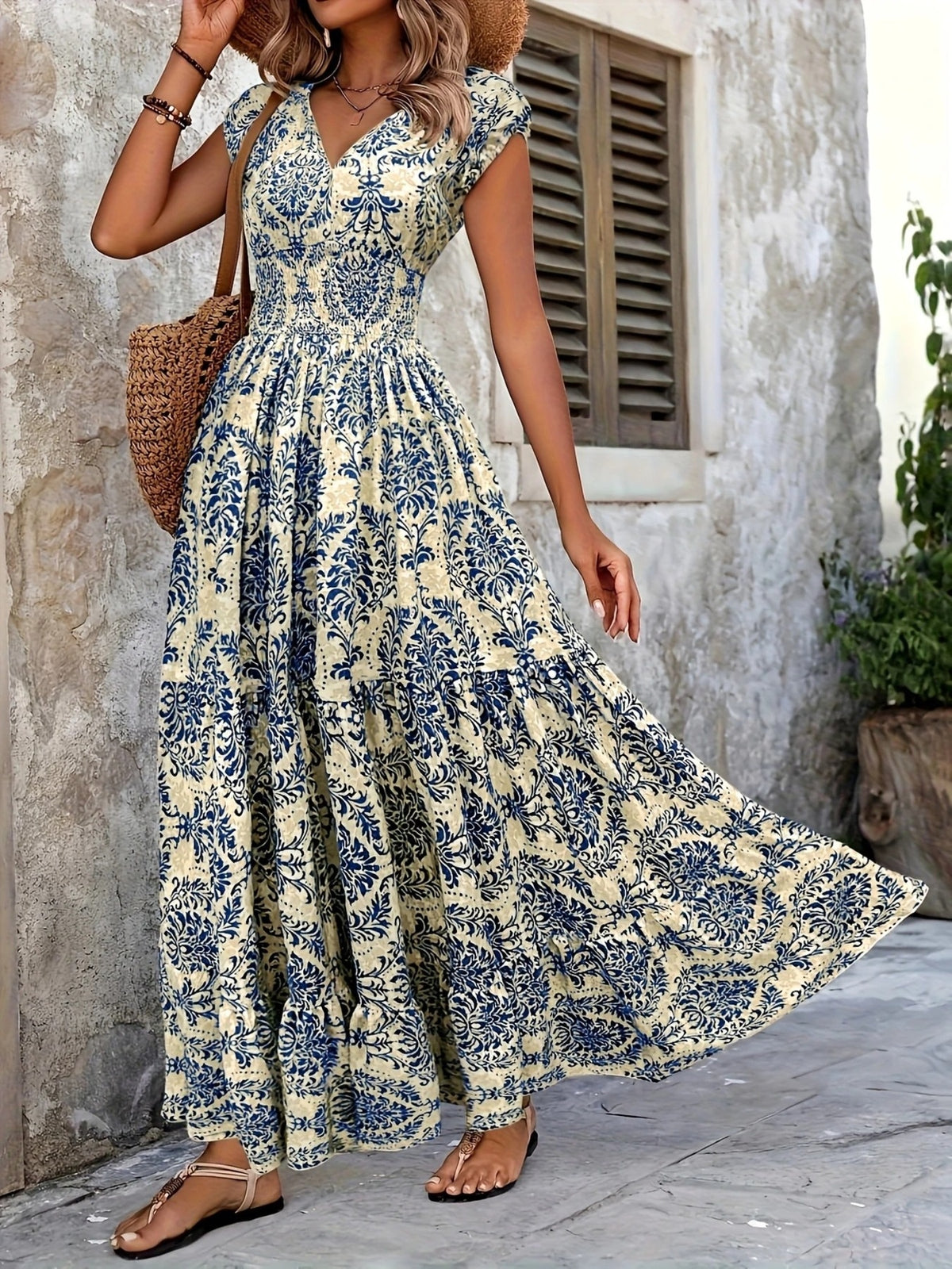 Purple floral cap-sleeve maxi dress shown front-on with a fitted smocked waist.