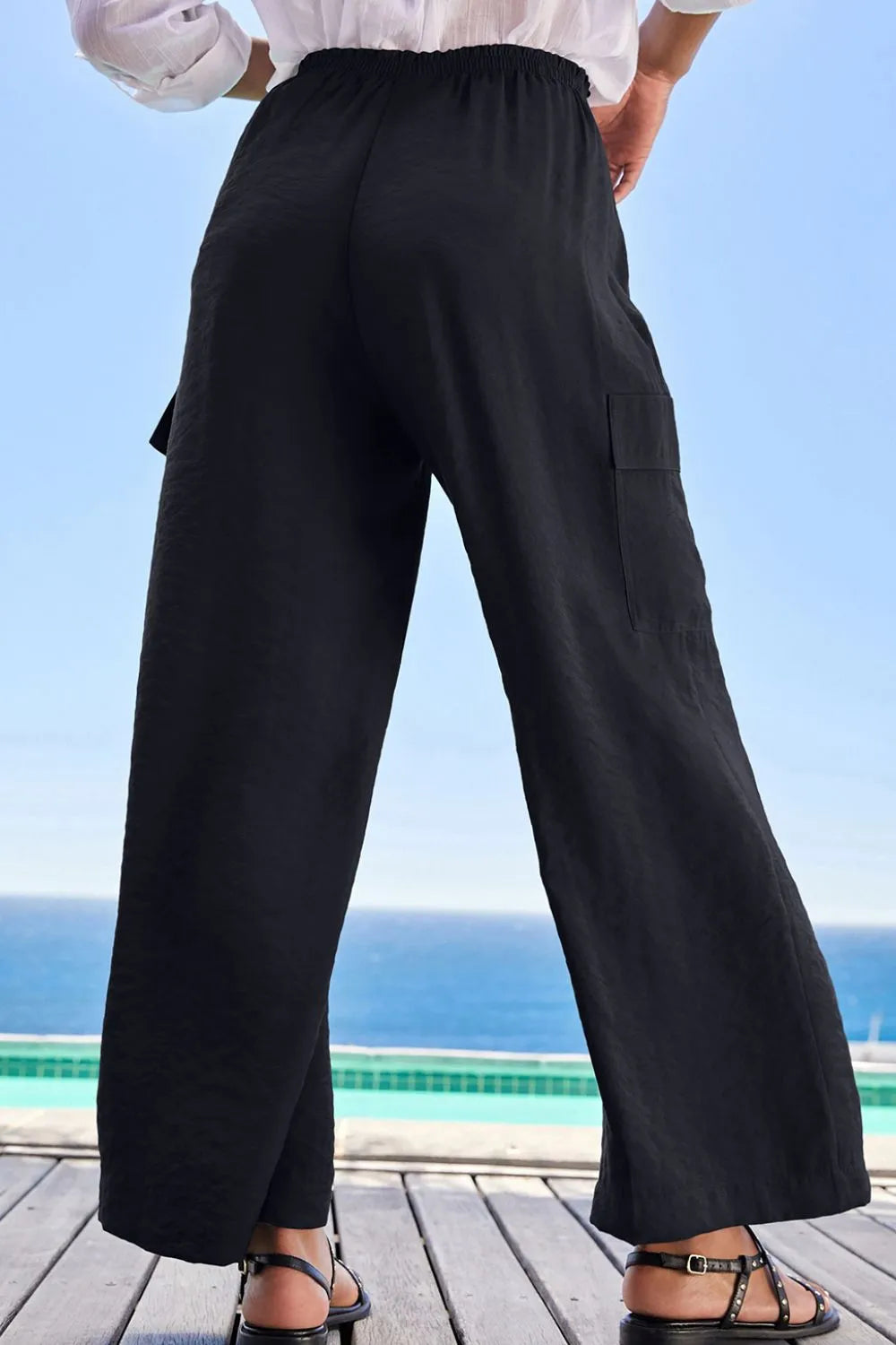 Back view of black wide-leg utility trousers