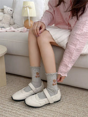 Gray bear socks worn with casual shoes