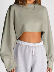 Front view of a pale sage cropped sweatshirt showing its loose fit and cropped hem.