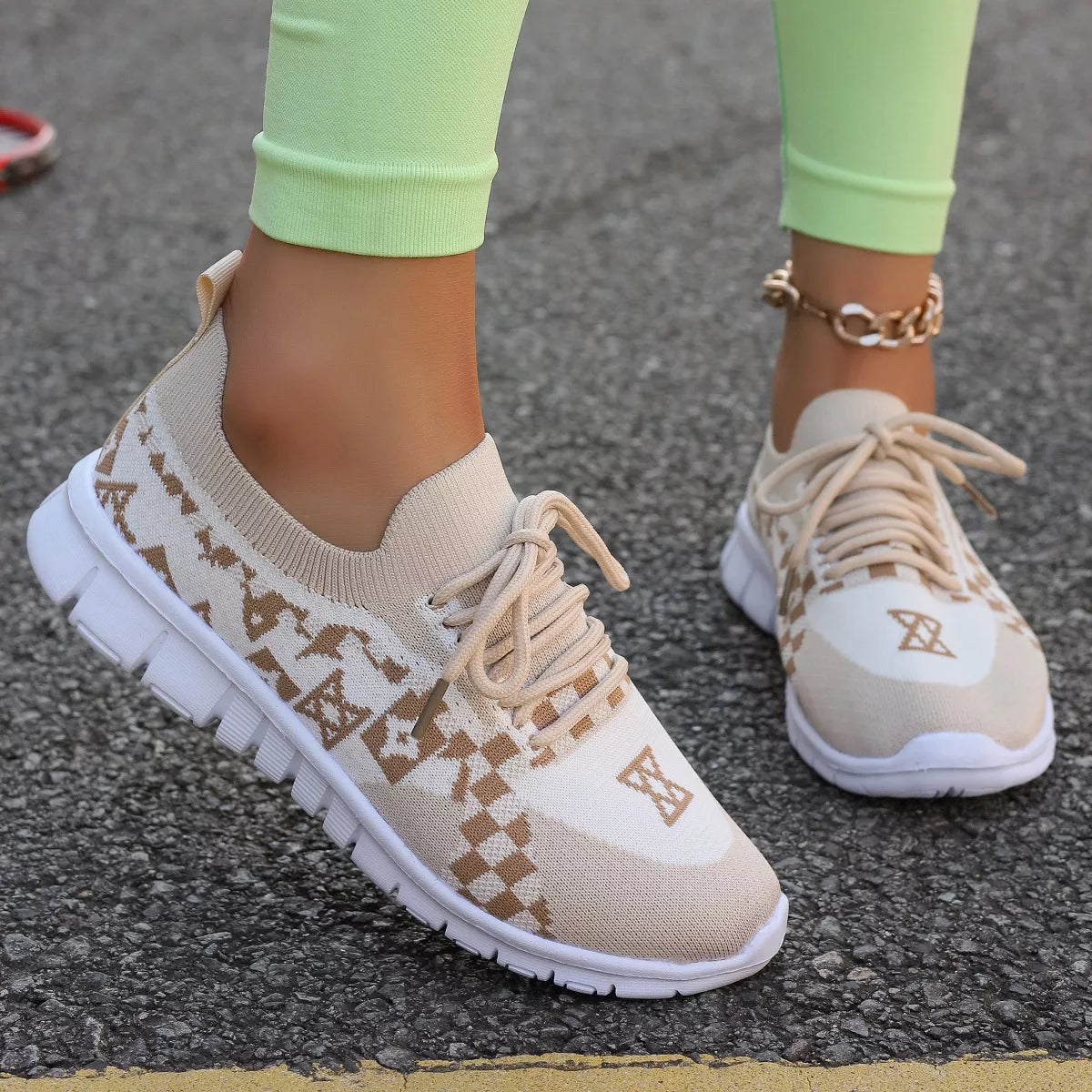 Pair of cream mesh sneakers with tan geometric pattern, front three-quarter view