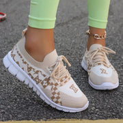 Pair of cream mesh sneakers with tan geometric pattern, front three-quarter view