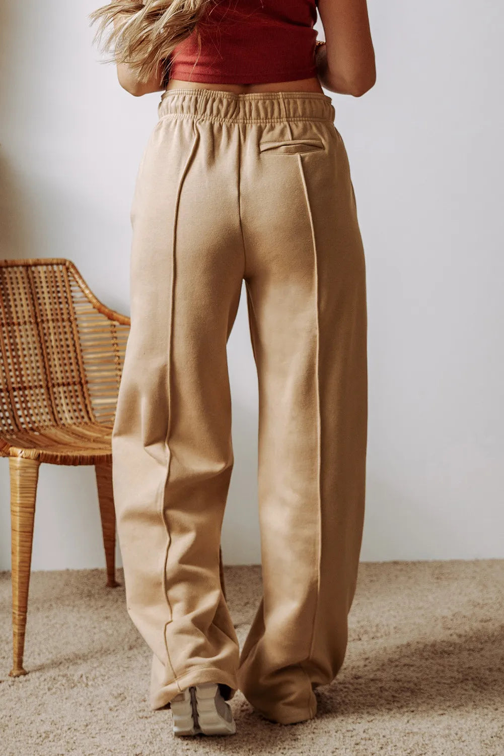 Back view of tan wide-leg pants with an elastic waist.