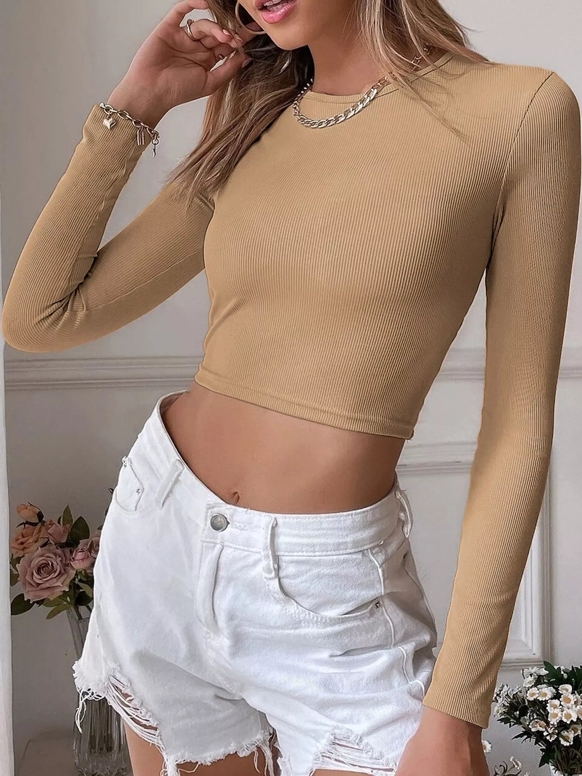 Tan long-sleeve cropped top shown from the front at an angle