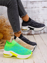 Black patterned mesh platform trainers worn beside lime green and beige colour options