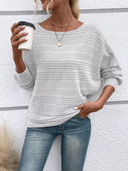 Women’s ribbed round-neck long-sleeve top in white front view holding cup