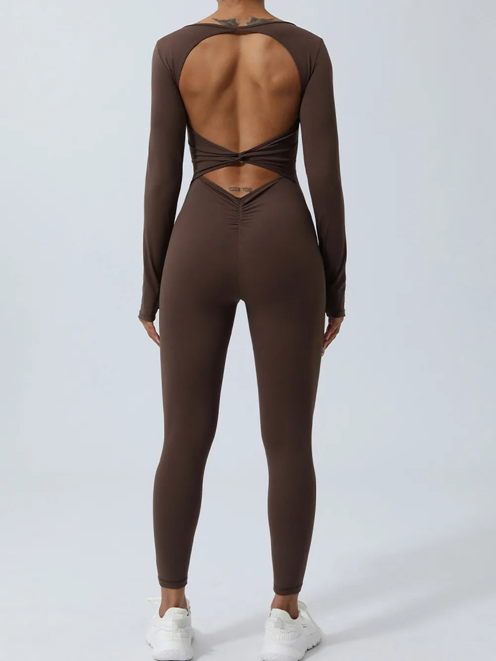 Brown jumpsuit shown from behind, highlighting open back