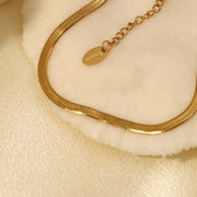Close-up of flat-link gold-tone necklace and adjustable clasp