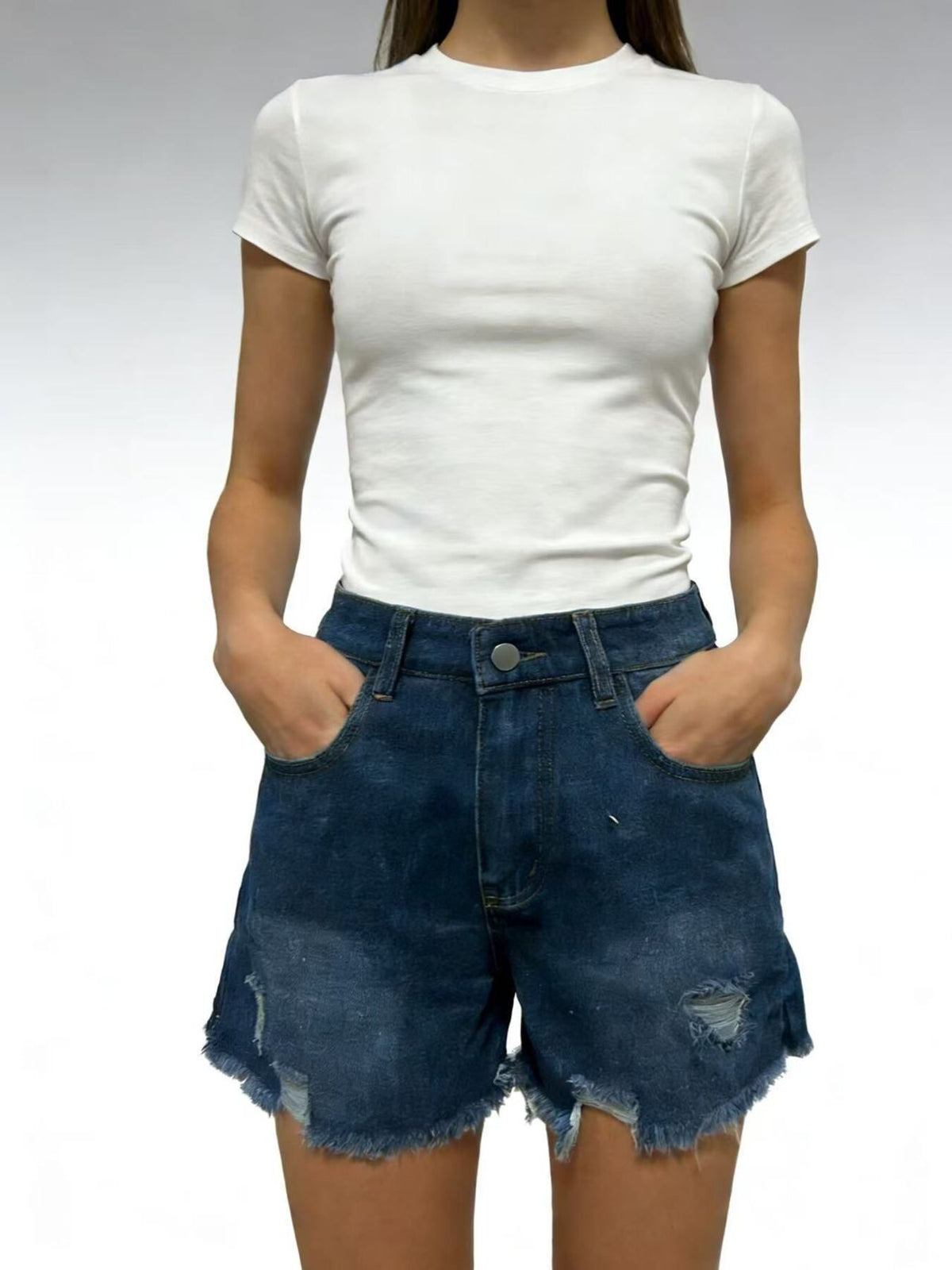 Front view of dark blue distressed denim shorts with frayed hems and front pockets, worn with a white T-shirt