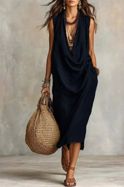 Black sleeveless midi dress with deep draped neckline, full-length front view