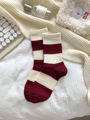 Pair of burgundy-and-cream striped socks