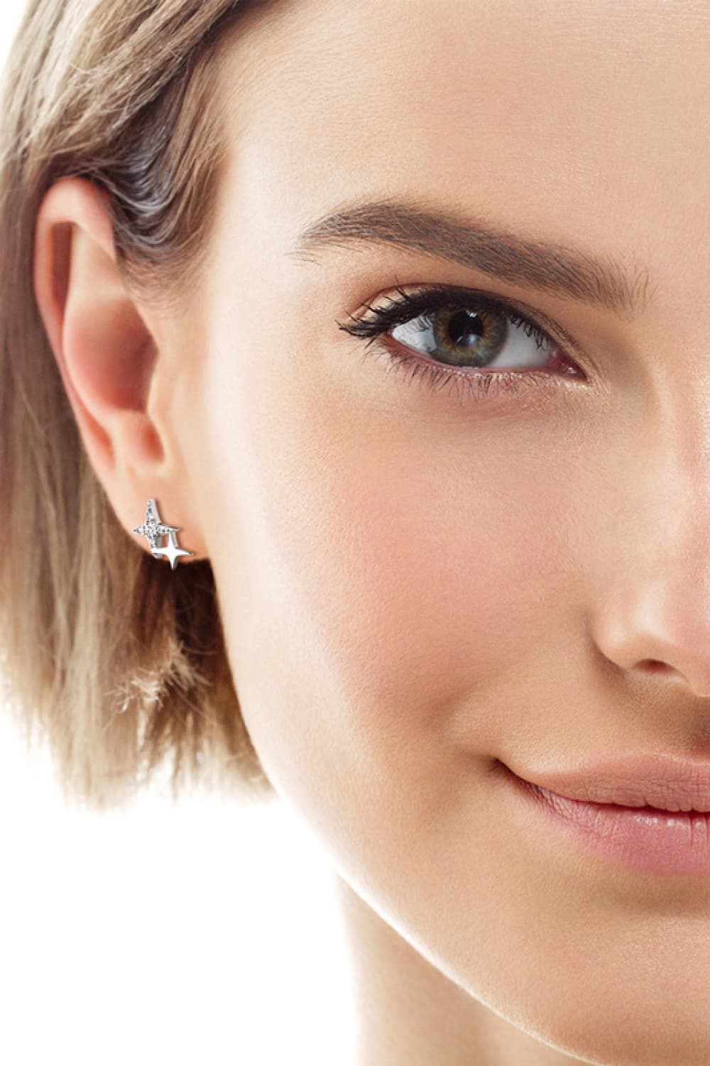 Model wearing a silver-tone open star-shaped stud earring