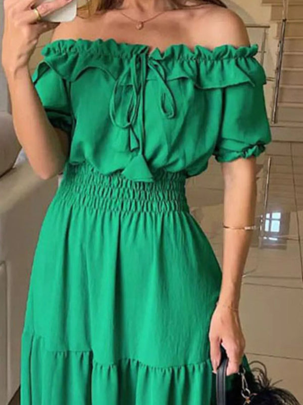 Close view of green maxi dress showing off-shoulder ruffles and smocked waist