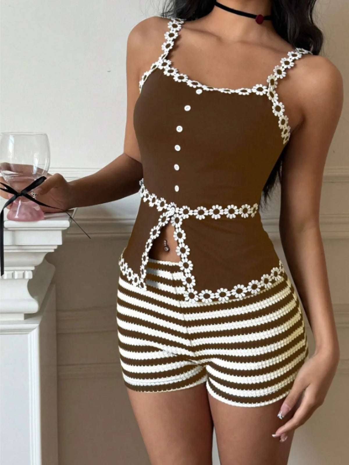 Model wearing brown striped shorts and matching trimmed top