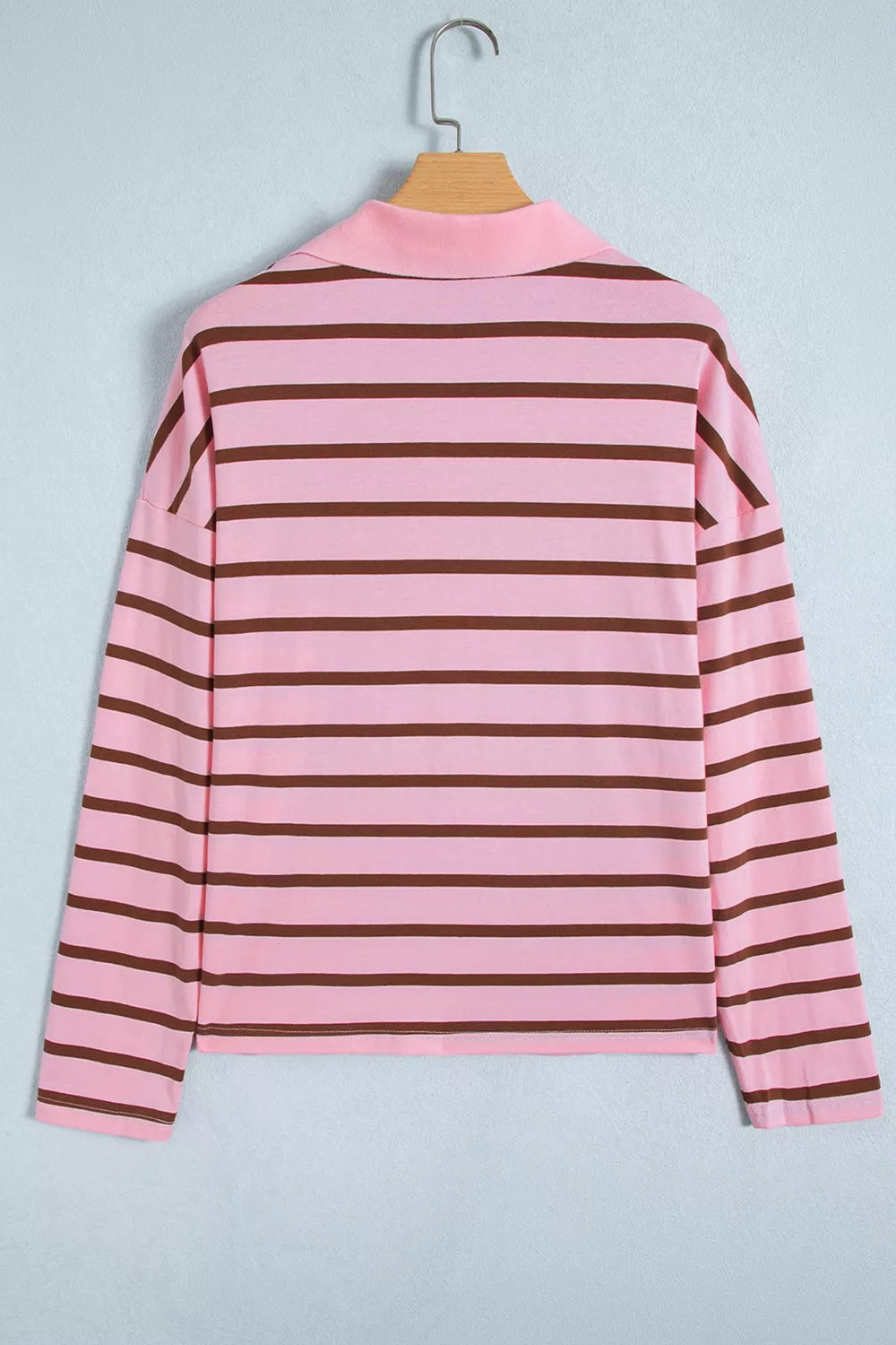 Back view of pink and brown striped shirt on a hanger.