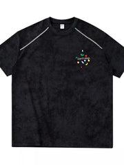 Front view of black washed T-shirt with small colorful chest graphic
