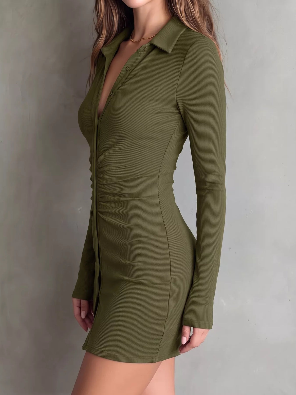 Side view of olive ruched dress with fitted skirt and long sleeve.