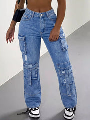 Front view of blue distressed cargo jeans showing multiple leg pockets and black-and-white trainers