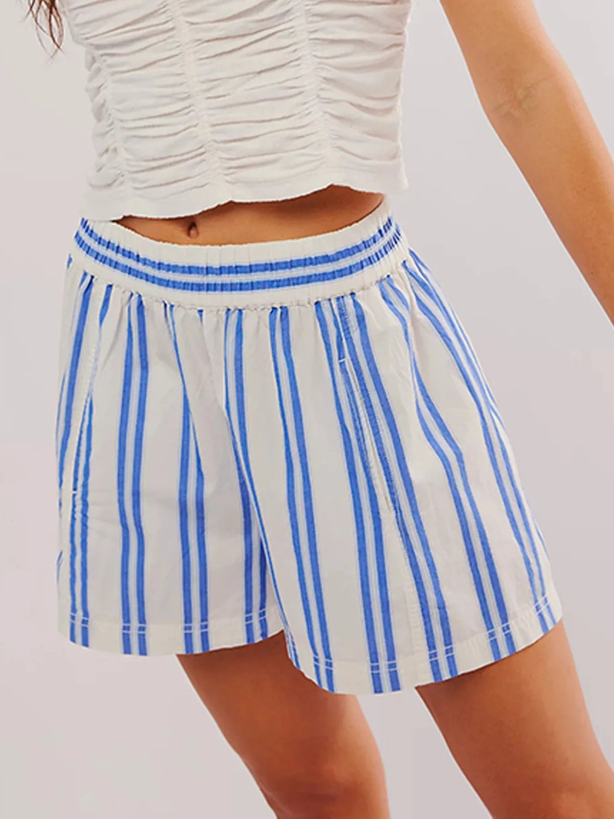 White shorts with bold blue vertical stripes and elastic waist