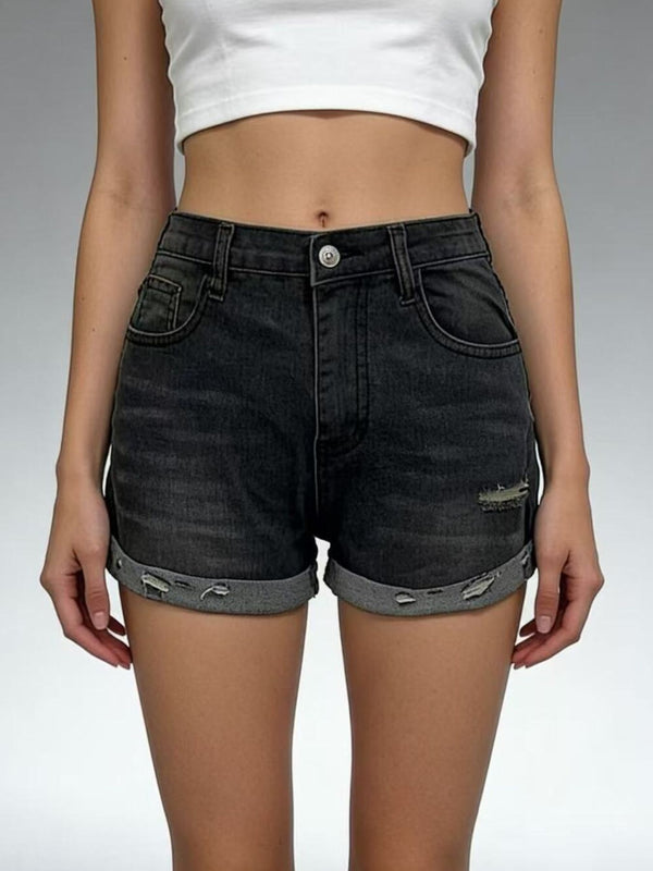 Front view of black roll-up denim shorts on model