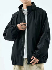 Black raglan-sleeve jacket worn open over a white T-shirt