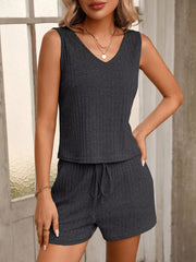 Closer front view of the charcoal set showing the V-neck tank and drawstring shorts.