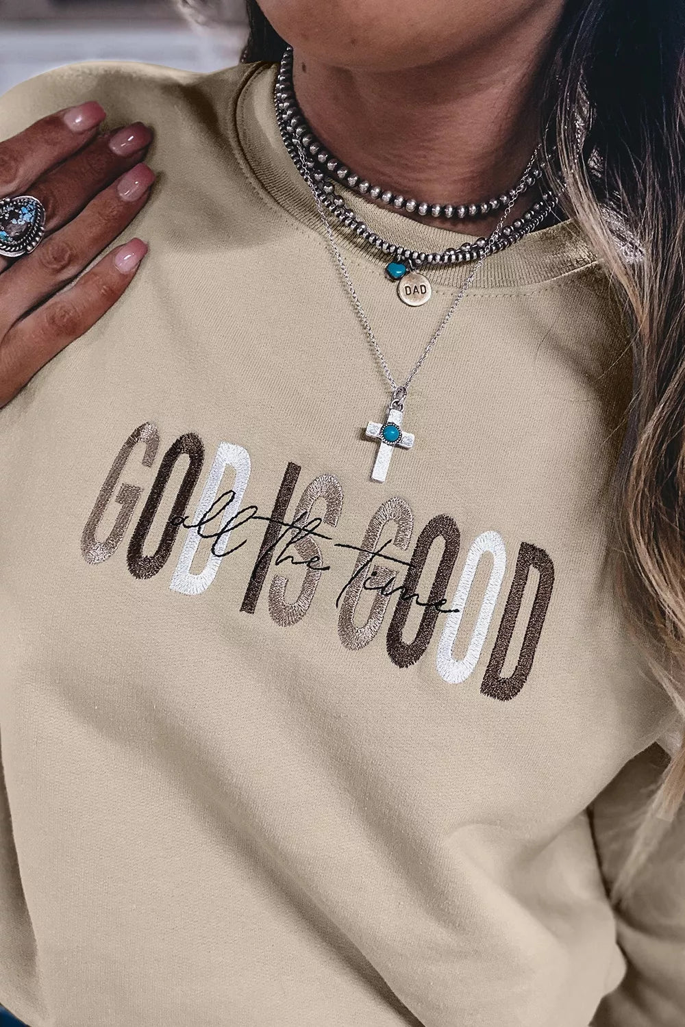 Close-up of God Is Good chest lettering and cross detail