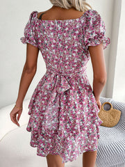 Back view of magenta floral mini dress with fitted waist and flared skirt