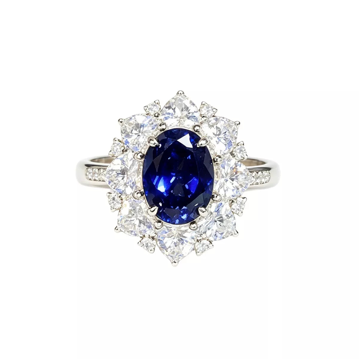 Close-up of an oval blue center stone and surrounding clear stones on a silver-tone ring