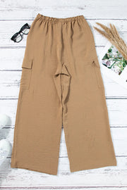 Back of tan utility trousers laid flat with wide straight legs