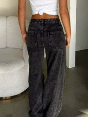 Back view of acid-wash wide-leg cargo jeans with patch pockets