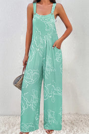 Front view of turquoise jumpsuit with hand in pocket