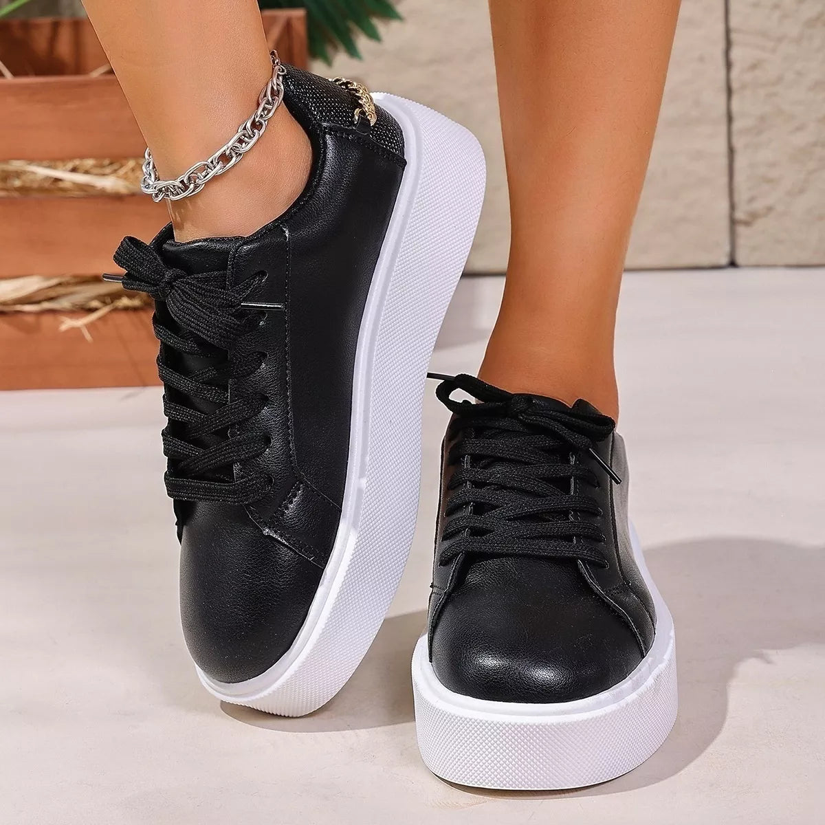 Front view of black lace-up platform sneakers