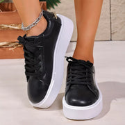 Front view of black lace-up platform sneakers