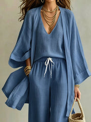 Closer front view of the blue cardigan set showing its layered V neckline and waist tie.