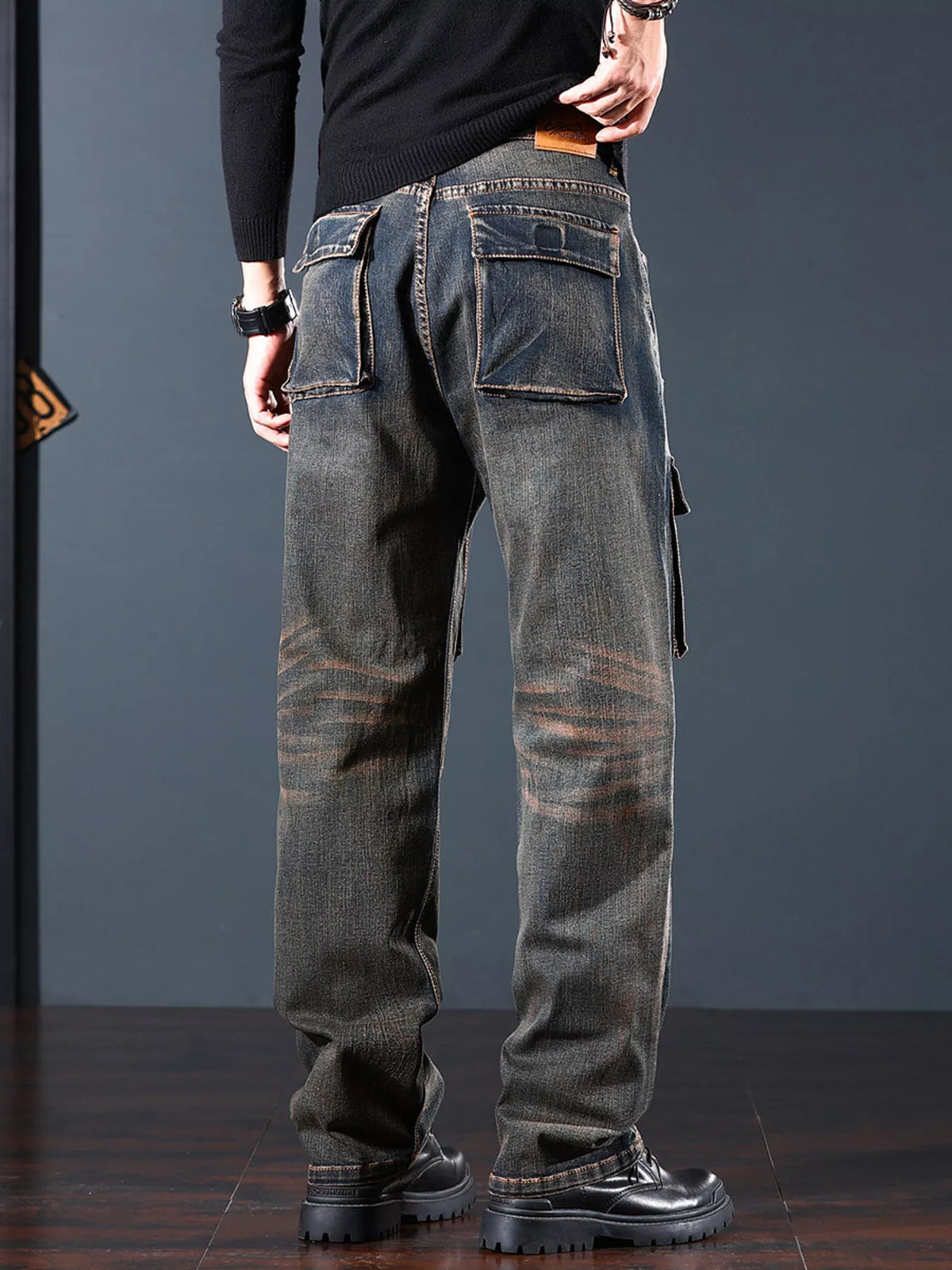 Back angled view of dark denim cargo jeans with rear pockets