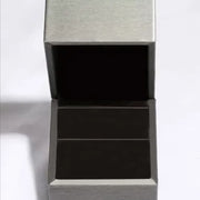 Open grey jewellery box with a dark interior