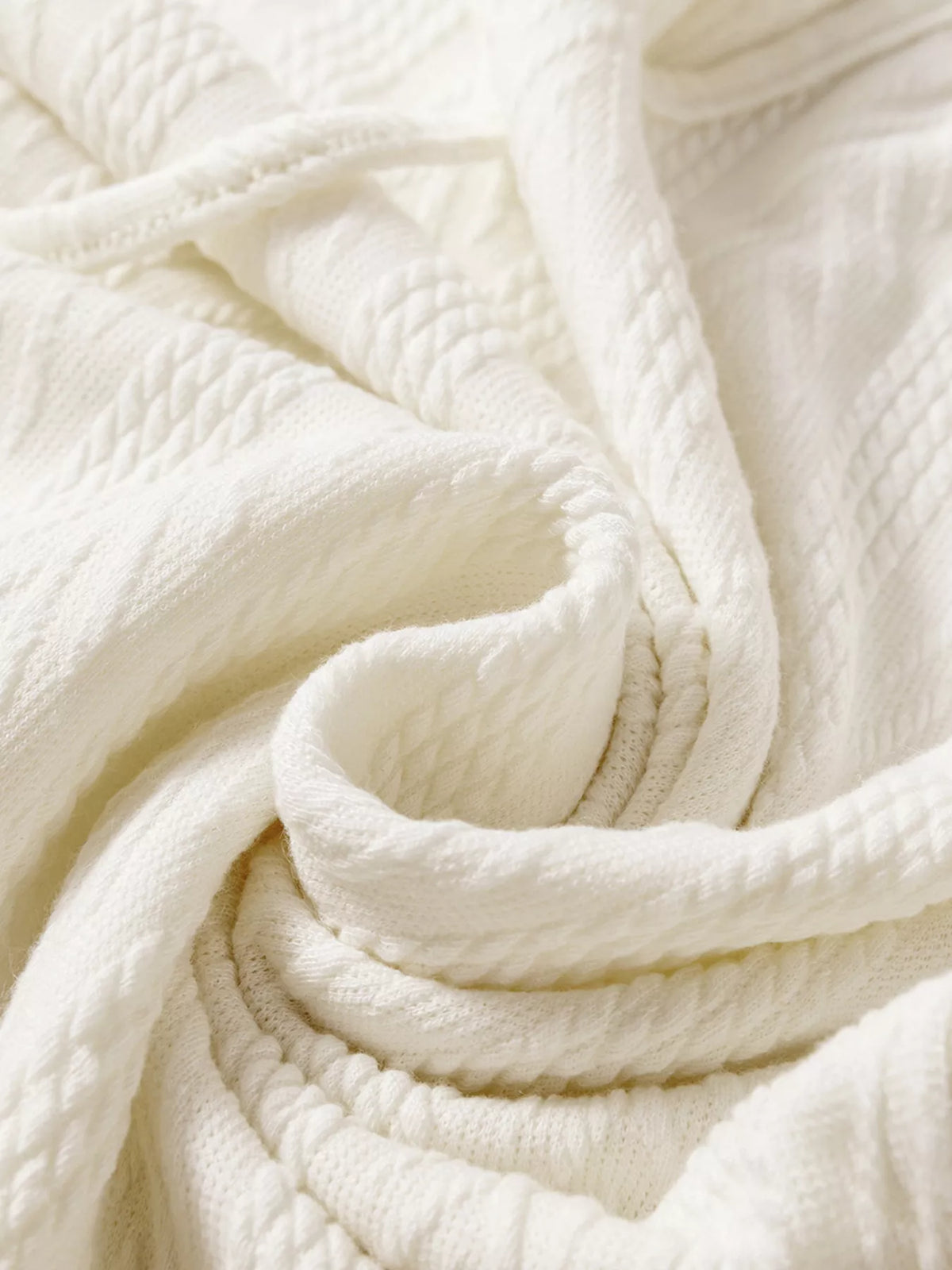 Close-up of soft textured ivory knit fabric