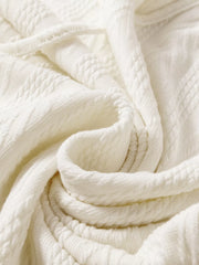 Close-up of soft textured ivory knit fabric