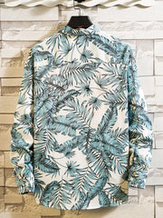 Back view of a white shirt with blue-green tropical leaf print