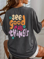 Back view of the dark gray oversized T-shirt with colorful lettering and flower graphics