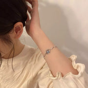 Celestial-style silver bracelet shown on a model's wrist