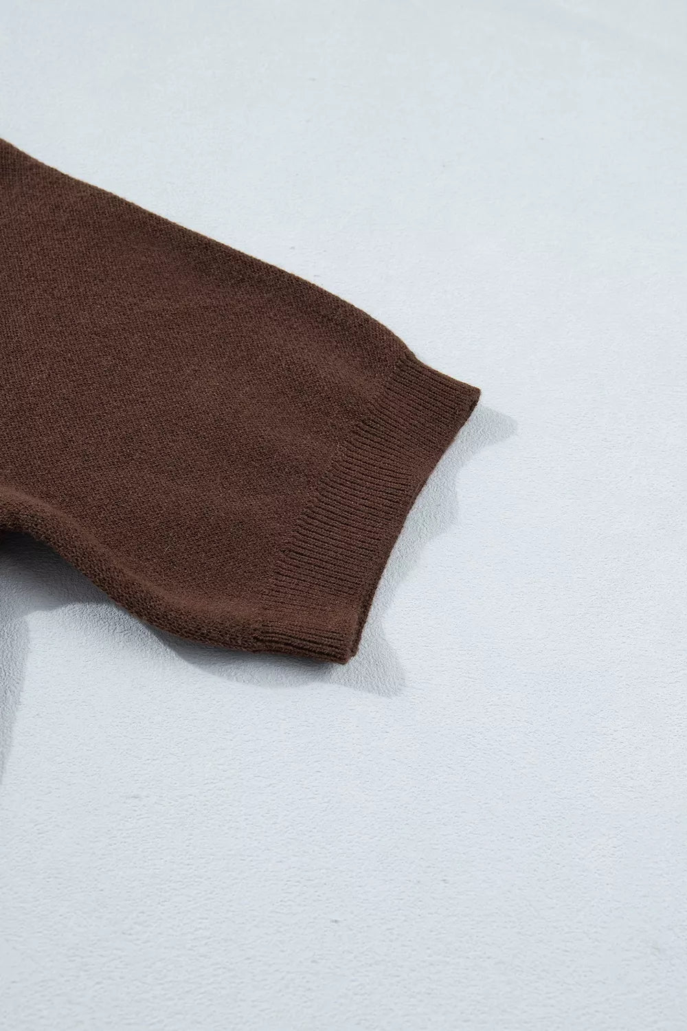 Detail of brown short sleeve with a straight finished edge