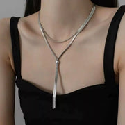 Silver layered snake-chain Y necklace worn over a black top