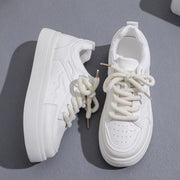 Top view of white platform lace-up sneakers