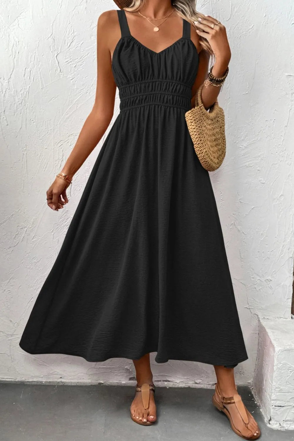 Front view showing the wide straps and gathered waist of black cami dress