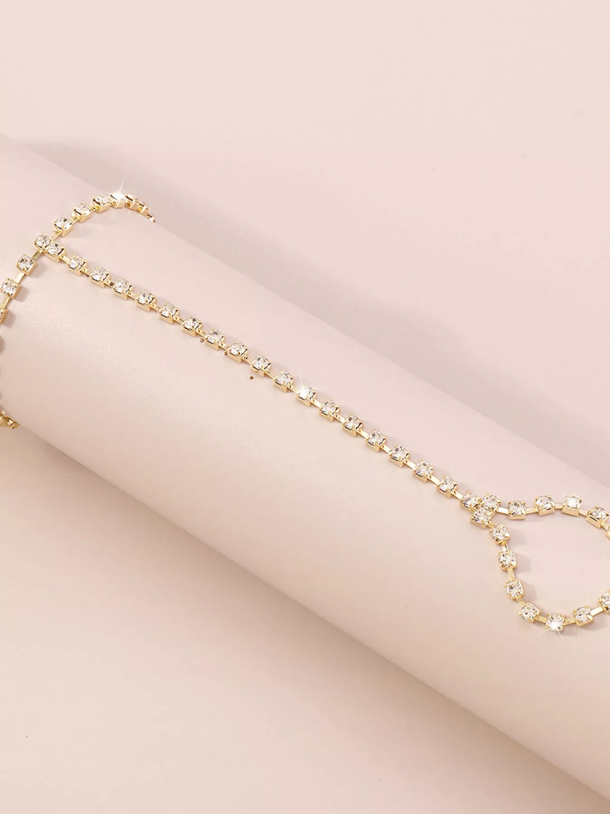 Gold-tone rhinestone bracelet hand chain shown flat