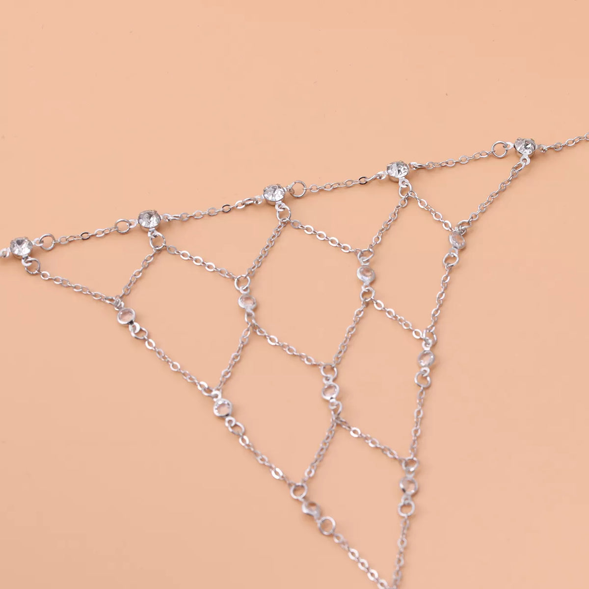 Close-up of rhinestone accents along the gold-tone hand chain